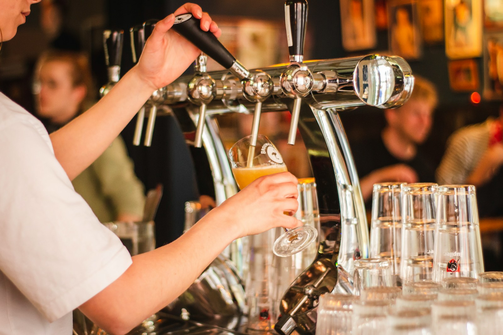 person holding handle of beer tap